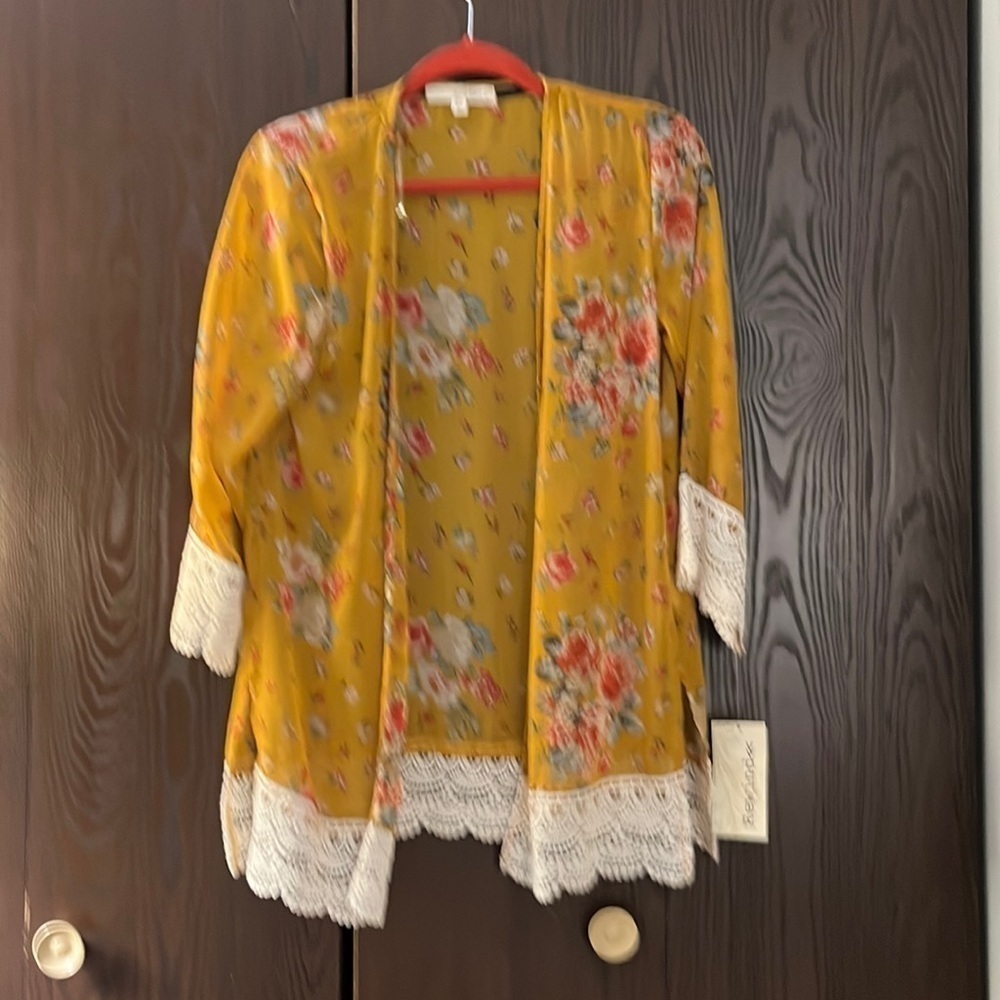 Rewind gold with red/ blue flowers shrug. NWT. Size XS.